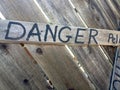 Danger keep out peligro sign painted on wood fence Royalty Free Stock Photo