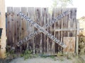 Danger keep out peligro sign painted on wood fence