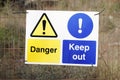 Danger keep out safety sign on fence at construction building site Royalty Free Stock Photo