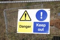 Danger keep out safety sign on fence at construction building site Royalty Free Stock Photo