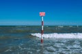 DANGER label in three languages standing at sea