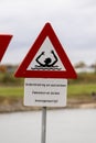 Danger for life sign next to a river and port entrance Royalty Free Stock Photo