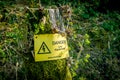 Danger Live Equipment sign on a tree stump