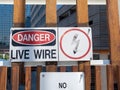 Danger live wire power lightning bolt warning sign posted near hazard