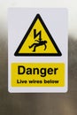 Danger Live Wires Below Warning Sign on metal sheet