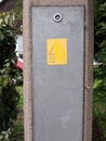 A danger live wires yellow and black emergency warning sign on a