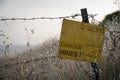 Danger mines - yellow warning sign next to a mine field, close to the border with Syria, in the Golan Heights, Israel Royalty Free Stock Photo