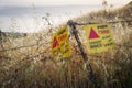 Danger mines -  yellow warning sign next to a mine field, close to the border with Syria, in the Golan Heights, Israel Royalty Free Stock Photo