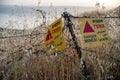 Danger mines - yellow warning sign next to a mine field, close to the border with Syria, in the Golan Heights, Israel Royalty Free Stock Photo