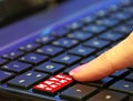 Danger online internet dark web hate crime user finger pressing pushing red button computer Royalty Free Stock Photo