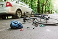 Danger place. Bicycle and silver colored car accident on the road at forest at daytime Royalty Free Stock Photo