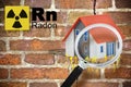 The danger of radon gas in buildings - concept with periodic table of the elements, radioactive warning symbol and home icon seen