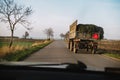 Danger in the road. tractor with grass on the street, view from Royalty Free Stock Photo