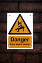 Danger sign on a brick wall