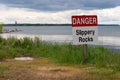 Danger Sign in Grass on the Lakeshore