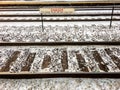 Danger sign hovers over snow-covered train tracks. Royalty Free Stock Photo
