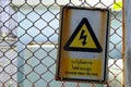 Danger sign on the metal fence, caution of danger of electricity Royalty Free Stock Photo