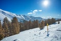 Danger sign on the side of a mountain ski track over high peaks Royalty Free Stock Photo