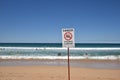 Danger Sign, Surfers and other people having good time at famous Manly Beach in Sydney, Australia Royalty Free Stock Photo