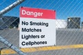 Danger sign on wire security fence to bulk petroleum storage tank yard