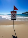 Danger swimming sign beach, red flag