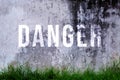 Danger text written with broken cement wall, Danger word on street