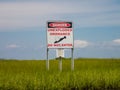 Danger unexploded ordnance do not enter posted above green sea