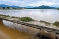 Damaged bridge across flowing river Royalty Free Stock Photo