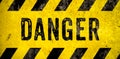 DANGER warning sign word text as stencil with yellow and black stripes painted over concrete wall danger background Royalty Free Stock Photo