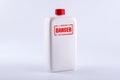 Danger. White plastic bottle on a white background