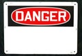 Generic danger sign hanging on the wall Royalty Free Stock Photo