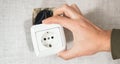 Dangerous bad,broken socket,plug in bathroom,falling out of wall. Outlet installation in old apartment. Poor electrical Royalty Free Stock Photo