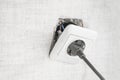 Dangerous bad,broken socket,plug in bathroom,falling out of wall. Outlet installation in old apartment. Poor electrical Royalty Free Stock Photo