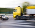 Dangerous city traffic situation between a car and a truck in motion blur Royalty Free Stock Photo