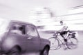 Dangerous city traffic situation with a cyclist and a car Royalty Free Stock Photo