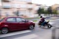 Dangerous city traffic situation with a motorcyclist and a car Royalty Free Stock Photo