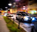 Dangerous city traffic situation with a motorcyclist and a car in motion blur