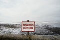 Dangerous Cliff Edge Sign, Ocean Covered With Mist In The Background