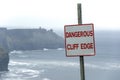Dangerous Cliff Edge Sign In Overcast Weather At Cliffs Of Moher In Ireland. Danger Sign Warning.
