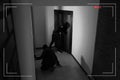 Dangerous criminals with crow bar intruding into apartment, view through CCTV camera