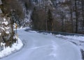 Dangerous curve of a frozen mountain road