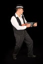 Dangerous gangster with 1920 style clothes standing with gun Royalty Free Stock Photo