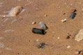 Dangerous glass fragments from broken bottles on the coast of the sea. Glass dangerous trash on the beach