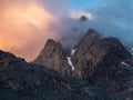 Dangerous gorge. Dramatic fog among giant rocky mountains. Ghostly atmospheric view to big cliff in cloudy sky. Low clouds and Royalty Free Stock Photo