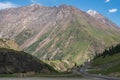 Dangerous gravel mountain road to Kumtor gold mine. Serpentine road to Sarymoynak mountain pass. Travel, tourism in Kyrgyzstan