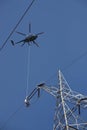Dangerous High Voltage Power Line Work From A Helicopter Royalty Free Stock Photo