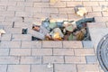 Dangerous hole for pedestrians on damaged sidewalk with broken bricks on the urban city street Royalty Free Stock Photo