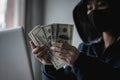 Dangerous Hooded Hacker held the money Royalty Free Stock Photo