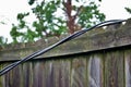 Dangerous live downed power line draped across fence Royalty Free Stock Photo