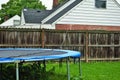 Dangerous live downed power line draped across fence and trampoline Royalty Free Stock Photo